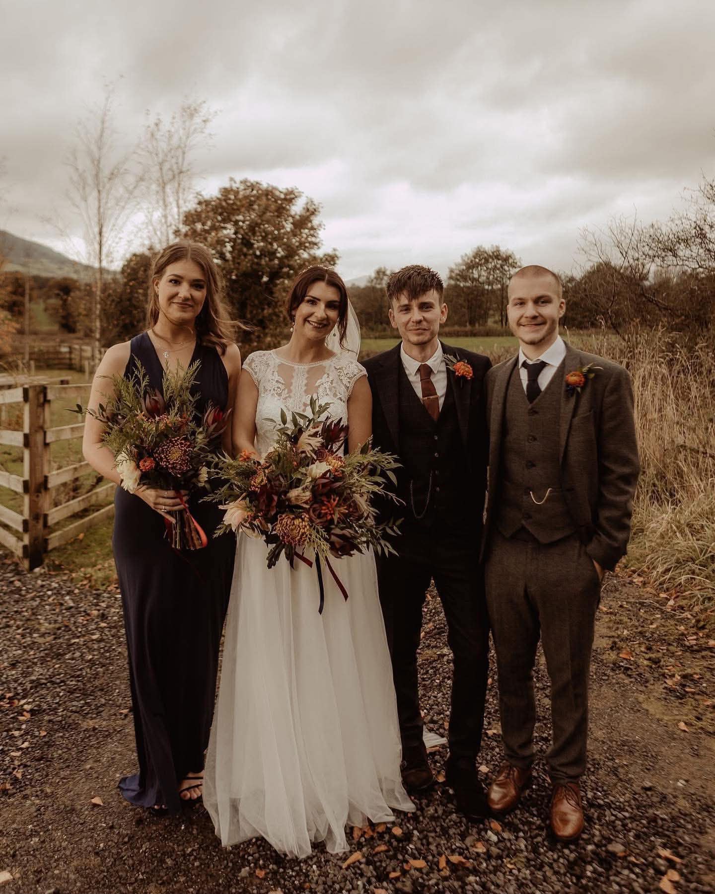 Bride and wedding party with natural autumnal bouquets and buttonholes