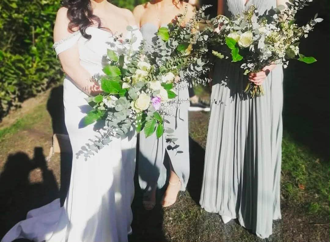 Bridal party holding airy white and eucalyptus bouquets