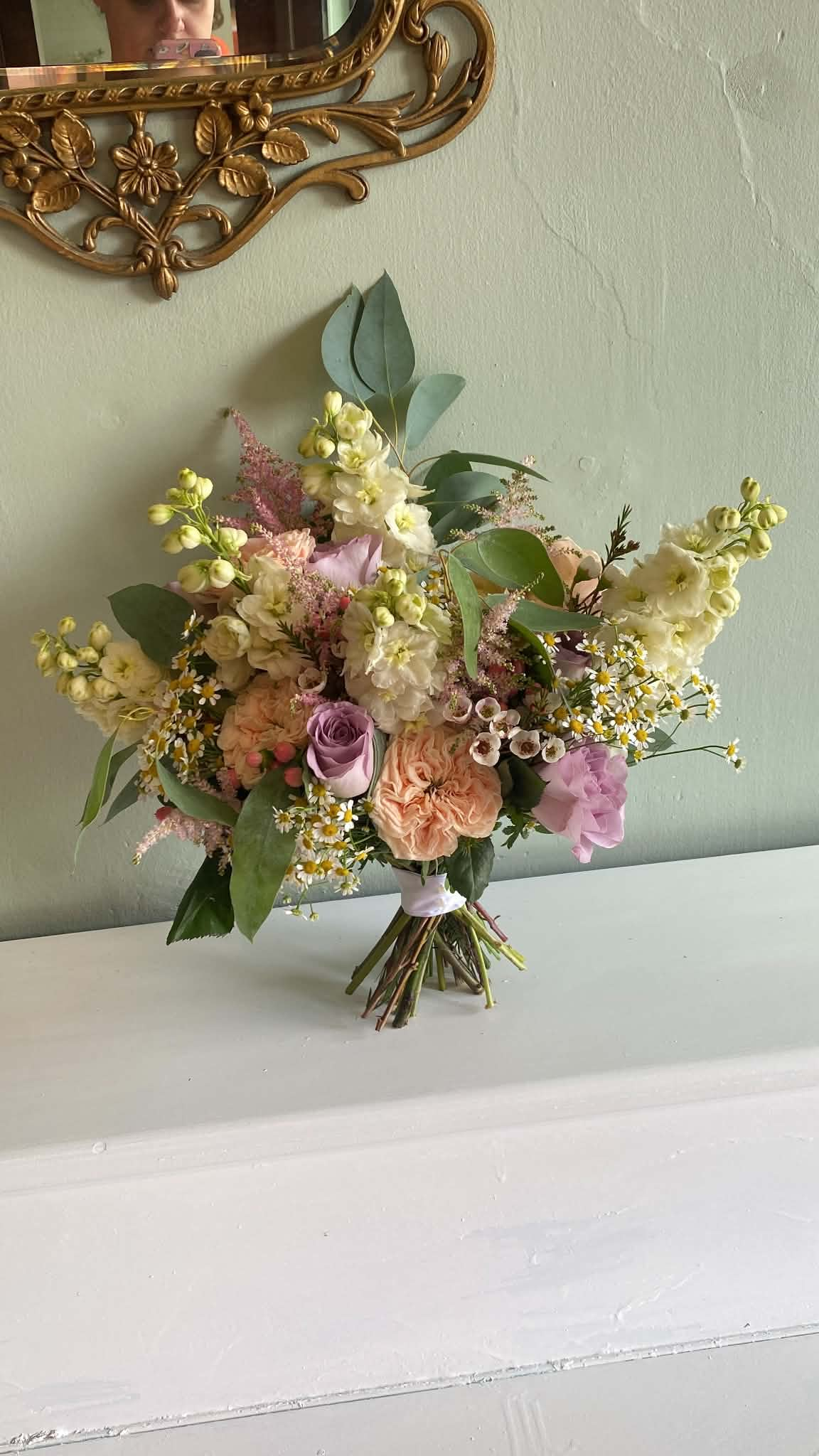 Pastel bridal bouquet with lavender and peach roses, white flowers and eucalyptus